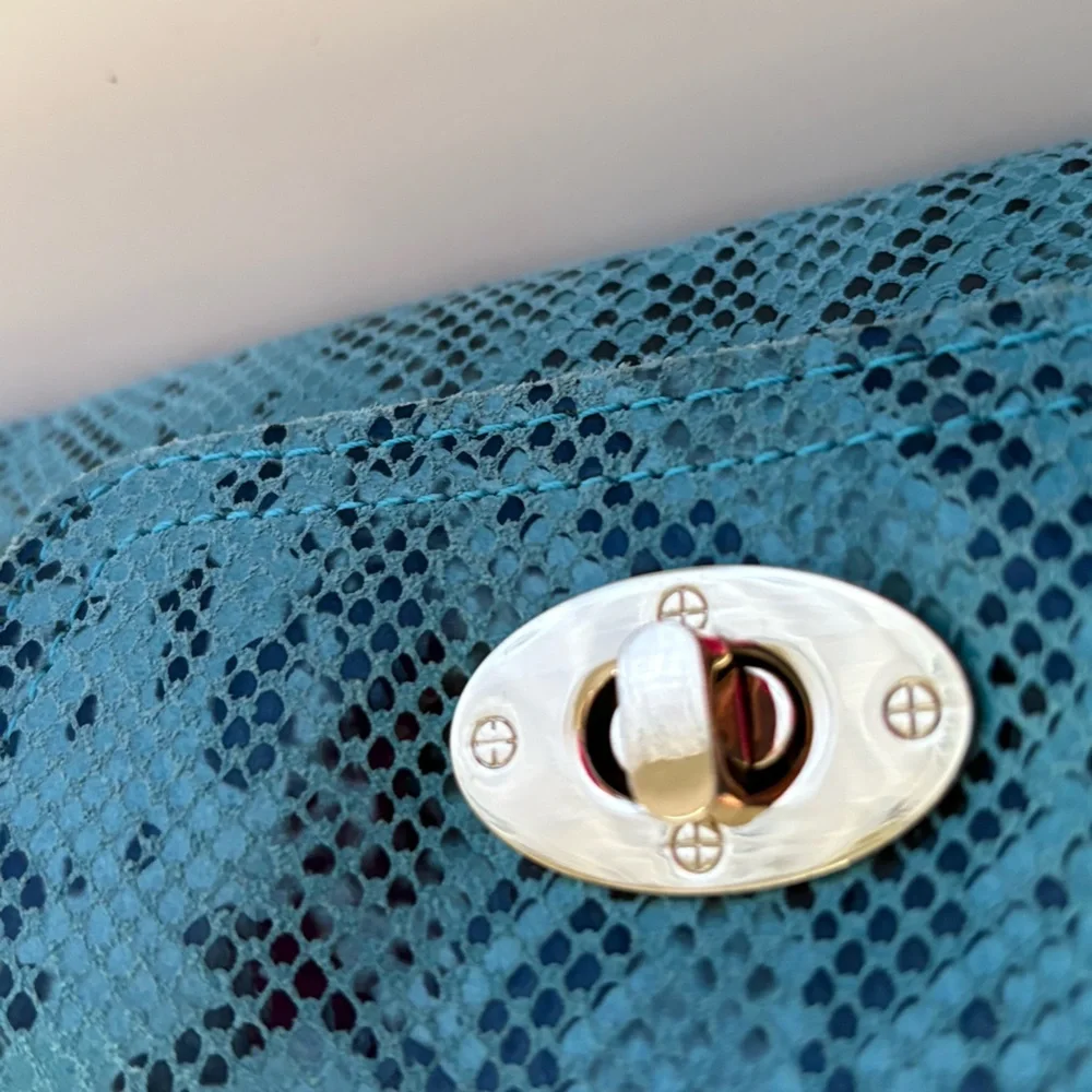 Turquoise python or snakeskin patterned leather clutch bag a twist-lock closure